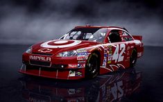 a red race car with the number 32 imppla painted on it