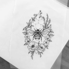 some paper with flowers and a bee on it