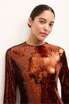 This simple crewneck dress is the perfect canvas for head-to-toe sequins—no extra embellishment necessary. And in a warm Cinnamon hue, the stylish silhouette delivers instant autumn glamor. -Satin piping trim around neck-Non-stretch sequin fabric-Center back invisible zipper-Fitted through body and sleeve with side slits-100% polyester-Fully lined-Care Instructions: hand wash only with gentle detergent and flat dry Fall Festive Sequin Dress With Contrast Sequin, Festive Fall Sequin Dress With Contrast Sequins, Contrast Sequin Dress For Fall, Festive Fall Contrast Sequin Dress, Fall Party Dress With Crew Neck, Chic Sequin Dress For Fall, Festive Long Sleeve Sequin Dress For Fall, Fitted Sequin Dress With Crew Neck, Embellished Sequin Dress For Festive Fall Events