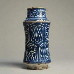 a blue and white vase sitting on top of a table