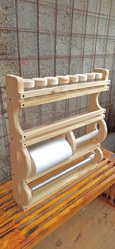 a wooden bench with a roll of toilet paper on it