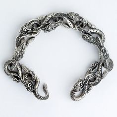 - 100% solid sterling silver- Bracelet weight: 94 grams- Bracelet width: 19 mm. Handmade Sterling Silver Collectible Bracelet, Symbolic Silver Metal Bracelets, Luxury Formal Snake Bracelet, Luxury Snake-shaped Formal Bracelets, Elegant Silver Snake-shaped Bracelets, Silver Snake-shaped Bracelets For Gifts, Army Rings, Silver Snake Bracelet, Gothic Bracelet