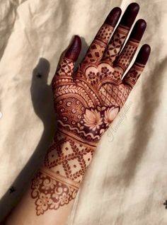 the hand is decorated with henna designs on it