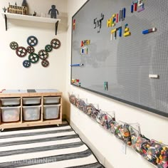 a room with toys and legos on the wall next to a playroom area