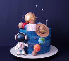 a birthday cake with an astronaut and planets on it