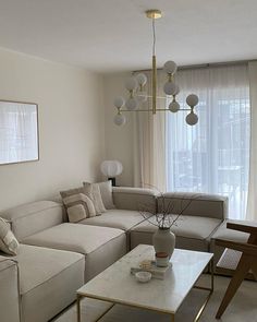 a living room filled with furniture and a large window