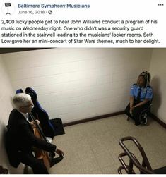 two people sitting in a room with guitars