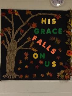 a bulletin board that says his grace falls on us with fall leaves and a tree