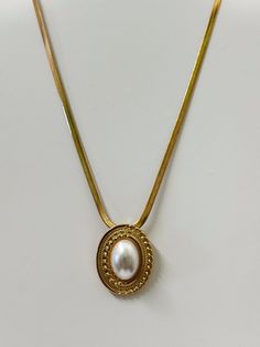 18k Vintage Gold Plating Faux Pearl Pendant Size: 1" x 1.25" Chain Length: 16" Extension Length: 2" Gold Oval Pendant Chain Jewelry, Gold Medallion Jewelry With Pearl Chain, Gold Medallion Jewelry With Pearl Pendant, Elegant Tarnish Resistant Locket Pendant Necklace, Classic Metal Pendant Chain Necklace, Classic Gold Pearl Chain Charm Necklaces, Gold Vintage Pearl Necklace With Clavicle Chain, Classic Gold Charm Necklace With Pearl Chain, Vintage Gold Pearl Necklace With Clavicle Chain