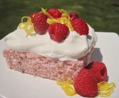 a piece of cake with raspberries on top