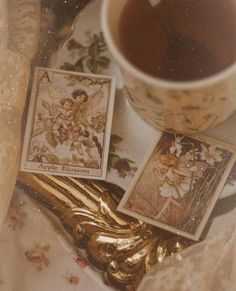 a cup of tea and some cards on a table