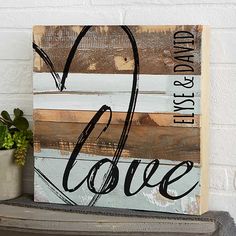 a wooden sign that says live, love and is next to a potted plant