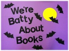 we're batty about books sign with bats flying around it and the moon in the background