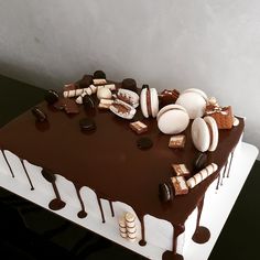 a chocolate cake with marshmallows and other dessert toppings on the top