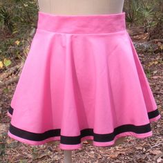 This mini skater skirt forms a full circle when you spin around, features a stripe near the hem and is available in any waist size and any mini length. The circle skirt is available in over 200 colors with black, white or any other color stripe. The circle / skater skirt closes in the back with an invisible zipper. The skirt is available in lengths from 12 inches to 16 inches. The navy blue skirt with white stripe in the first two pictures is shown in the 15 inch length. The candy pink skirt wit Fitted Mini Skirt For Cheerleading In Spring, Fitted Mini Skirt For Spring Cheerleading, Pink Fitted Full Mini Skirt, Retro Fitted Pink Skort, Spring Cheerleading Fitted Skirt, Pink Stretch Flared Skort, Spring Lined Skirt For Cheerleading, Fitted Cotton Skirt For Cheerleading, Mini Circle Skirt