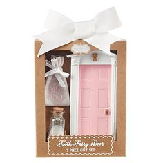 a pink door is in a cardboard box with a white ribbon around it and two bottles are next to it