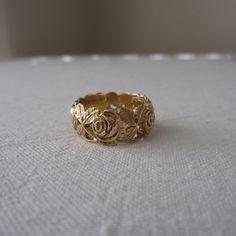 a gold ring sitting on top of a white cloth