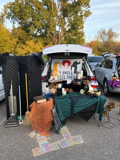 the back end of a van with an open trunk full of stuff and decorations on it