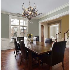 a dining room table with chairs and a chandelier