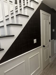 a white and black stair case in a house