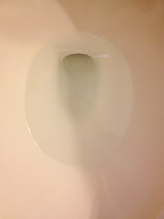 a white toilet bowl with the lid up