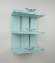 a shelf made out of wood with two metal handles on each side and one is painted blue