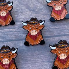 six brown bulls with hats and scarves on them