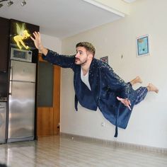 a man is flying through the air in his kitchen