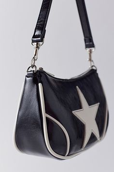 Motorcycle style baguette bag designed in smooth faux leather with contrast piping trim and a large star patch. Complete with a metal zipper closure and short shoulder strap. Features Daphne moto baguette bag Faux leather moto bag Contrast star detailing Zip closure Content + Care 100% Polyurethane Spot clean Imported Size Dimensions: 10" l x 3" w x 6" h Strap drop: 9.5" | Daphne Moto Baguette Bag in Black/White, Women's at Urban Outfitters Star Purse, Urban Outfitters Bag, Heeled Rain Boots, High Heel Rain Boots, Motorcycle Style, Baguette Bag, Backpack Tote Bag, Contrast Piping, Leather Moto