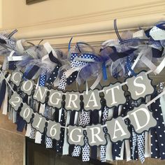 congratulations banner hanging from the fireplace with blue and white ribbon, polka dots and ribbons