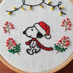 a cross stitch pattern with a dog wearing a santa hat