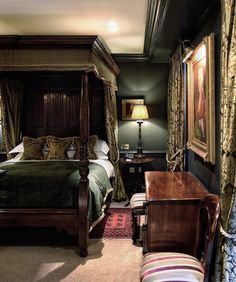 a bedroom with a canopy bed and green walls