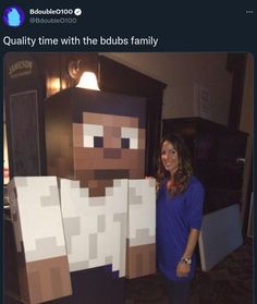 a woman standing next to two paper cut out of minecraft characters