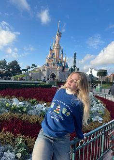 a woman standing in front of a castle