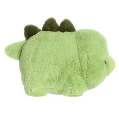 a green stuffed animal with horns on it's back and eyes closed to the side