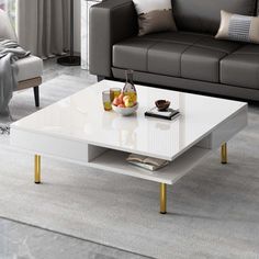 The sleek and modern design of this coffee table is sure to catch eyes. This coffee table provides a comfortable space for you to study, work, or have a relaxing afternoon tea after a tiring task. With two small hidden drawers and open storage shelves, this coffee table provides convenient storage for various items, such as remote controls, magazines, coasters, or other small essentials. The sturdy construction and the use of premium materials make this central table durability and longevity. Ev Square Center Table, Table Small Space, Coffee Table Small Space, Modern Square Coffee Table, Open Storage Shelves, Seating Ideas, Mesa Exterior, Wood Table Top, Coffee Table White