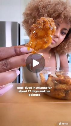 a woman eating food from a bowl on top of a wooden table with the caption and i lived in atlanta for about 17 days and i'm