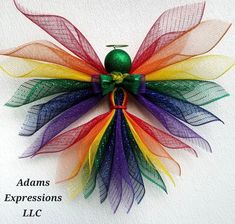 a colorful angel made out of mesh with an apple on it's back and the words adamss expressions lllc written below