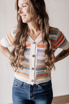 Say goodbye to boring layers! Our Multicolored Striped Short Sleeve Sweater Cardigan adds a pop of playful color while keeping you warm and stylish. Perfect for layering, this sweater cardigan is a fun and functional addition to your wardrobe. Fit: Relaxed Fit - True to size Lightweight sweater cardigan Button down V-neck Color: Multicolor stripes (Ivory and Orange) Fabric: 78% Acrylic / 22% Nylon Brand: Adora Have questions or need help deciding on fit? Want styling advice? Message us on our FB Cozy Color Block Cardigan For Spring, Knit Color Block Cardigan For Layering, Spring Color Block V-neck Cardigan, White Knit Cardigan With Color Block, White Knit Color Block Cardigan, V-neck Color Block Cardigan For Layering, White Color Block Cardigan For Layering, Playful Knit Cardigan For Fall, Trendy Multicolor Sweater For Layering