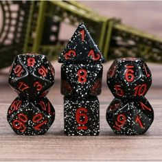 three black and red dice with numbers on them