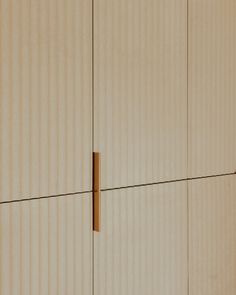 a close up view of the side of a white wall with brown lines on it