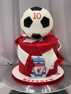 a cake with a soccer ball on top and the number 10 on it's side