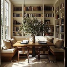 a living room filled with furniture and bookshelves next to a window covered in lots of books