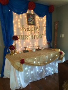 a birthday party table with lights and decorations