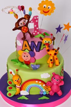 a birthday cake with animals and letters on it