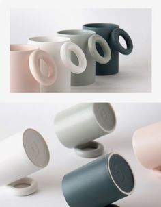 four different colored coffee cups sitting next to each other on a white surface and one is empty