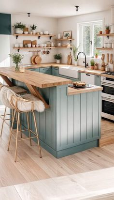 a kitchen with blue cabinets and wooden counter tops in the middle of it, along with two bar stools at the center of the island