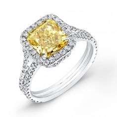 a fancy yellow diamond ring set with diamonds on the shoulders and sides, in white gold