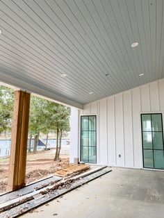 an empty room with white walls and wood beams on the ceiling is under construction in progress