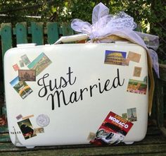 a suitcase that has been decorated with pictures and words on it, sitting on a bench